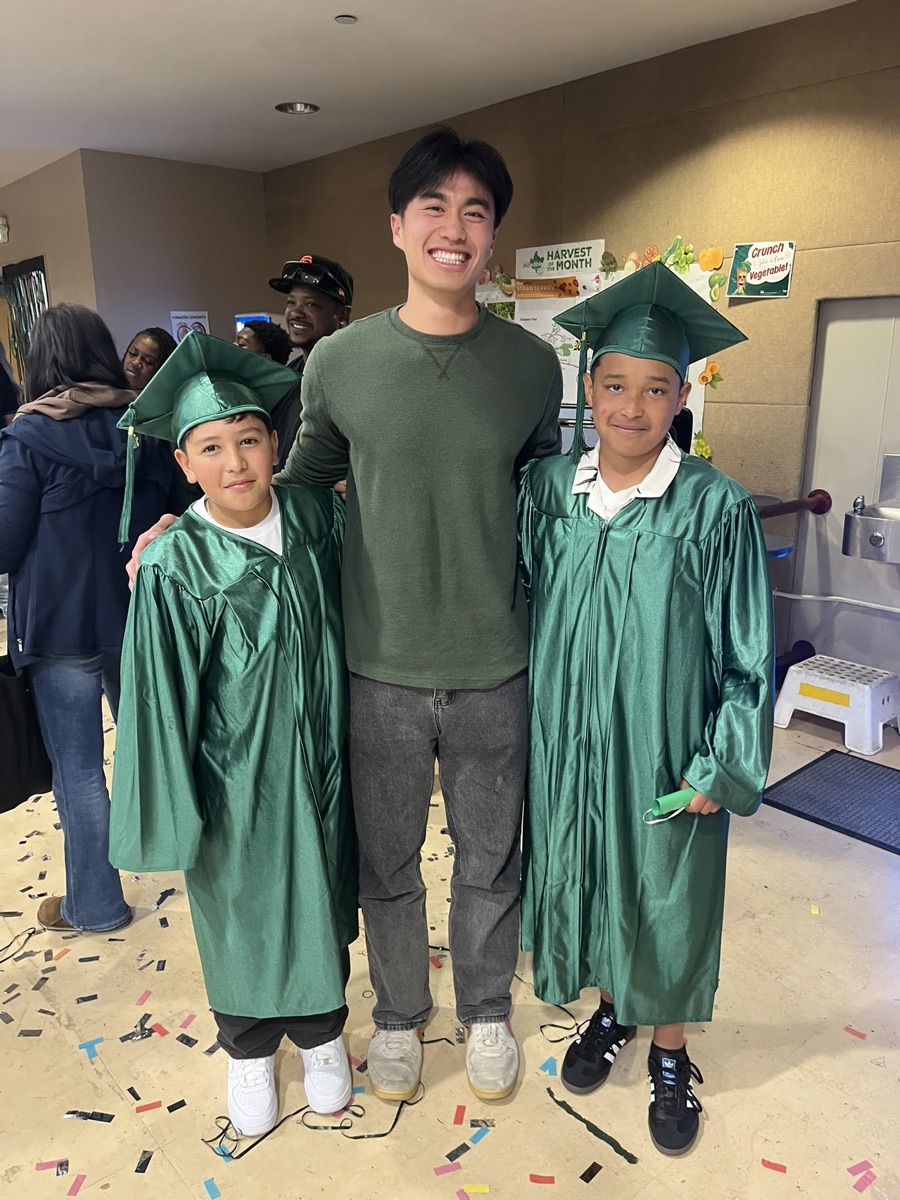 Sage mentor with students at a partner school